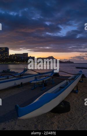 Canoë-kayak sur la plage de Waikiki au lever du soleil Banque D'Images
