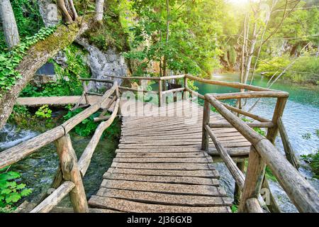 La jetée en bois au-dessus des chutes d'eau au bord du lac Milino Jezero. Parc national des lacs de Plitvice, en Croatie, dans la région de Lika. Banque D'Images