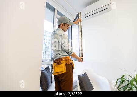 master changer une fenêtre à double vitrage dans une fenêtre en plastique, vue latérale Banque D'Images