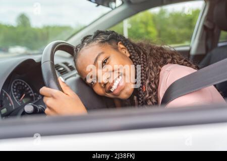 Jeune chauffeur adolescent noir assis dans sa nouvelle voiture Banque D'Images