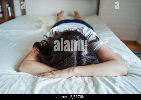 Triste, malheureux femme couché sur le lit dans la dépression. Maux de tête, stress, anxiété, tension, problèmes psychologiques. Mauvaise santé mentale, psychologue visiteur, psycho Banque D'Images