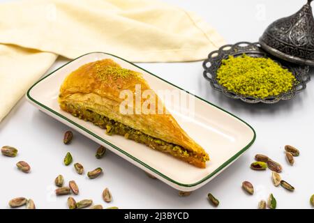 Tranche de carotte baklava sur fond blanc. Spécialités méditerranéennes traditionnelles. Pistache en gros plan. Nom local havuc dilim baklava Banque D'Images
