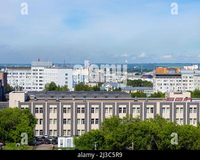 Kemerovo, Russie - 24 juin 2021. Paysage urbain à partir d'une hauteur - une zone industrielle avec des cheminées de fumée et une forêt avec des terres agricoles sur la h Banque D'Images