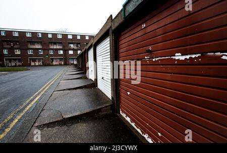 Une succession de conseil avec des logements sociaux dans des blocs de tours et des rangées de garages désutilisés dans le nord de l'Angleterre pendant la mise à niveau du gouvernement britannique Banque D'Images