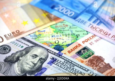 Dollars AMÉRICAINS, roubles russes et euro sur la carte de l'Ukraine. Concept de soutien américain et européen à Kiev au cours d'une opération militaire spéciale Banque D'Images
