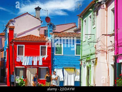 Venise (Burano), Italie - mai 9. 2019: Vue sur la place avec des maisons lumineuses colorées, la buanderie est suspendue à l'extérieur pour sécher, ciel bleu Banque D'Images