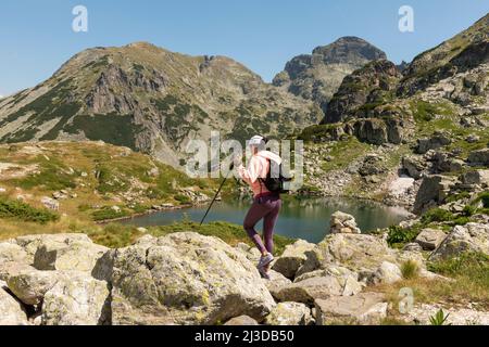 Randonnée en montagne, randonneuse en tenue colorée aux lacs Malyovitsa dans le parc national de Rila, montagne de Rila, Bulgarie, Europe Banque D'Images