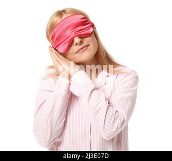 Femme mature en pyjama et avec masque de sommeil sur fond blanc Banque D'Images