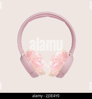 Casque doux rose avec boutons de fleurs au lieu des oreilles, design conceptuel sur le thème de la belle musique et de l'électronique moderne. Banque D'Images