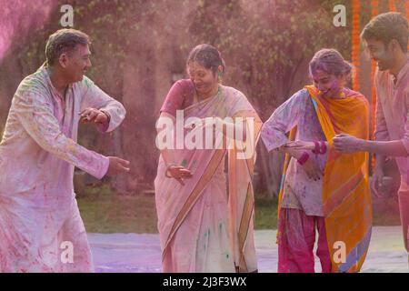 Bonne famille indienne dansant ensemble à l'occasion de Holi Banque D'Images