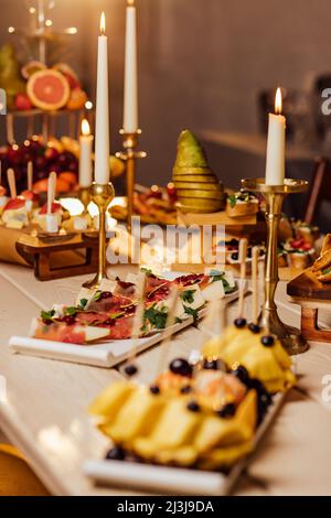 Table de dîner avec grill à viande, pommes de terre rôties, légumes, salades, sauces, en-cas et limonade, vue de dessus. Banque D'Images