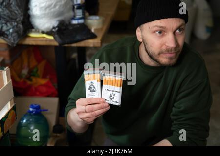 Kiev, Ukraine. 31st mars 2022. Un volontaire montre les cigarettes emballées par lui, car elles seront livrées à la ligne de front pour les soldats ukrainiens. Au fur et à mesure que la guerre progresse, les citoyens de Kiev se portent volontaires pour aider leur mère-patrie de différentes manières, comme distribuer de la nourriture aux personnes âgées et cuisiner pour les soldats de première ligne. (Image de crédit : © Alex Chan TSZ Yuk/SOPA Images via ZUMA Press Wire) Banque D'Images