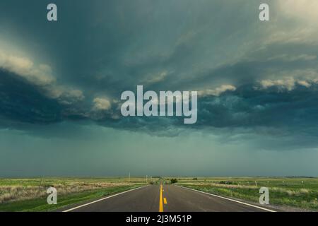 Un mur de pluie provenant d'un complexe d'orages monte la route pendant la saison des tempêtes à Tornado Alley, Kansas, États-Unis d'Amérique Banque D'Images