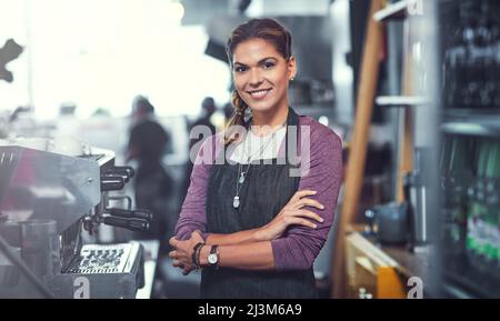 Posséder mon propre magasin a ses avantages. Portrait d'une jeune femme confiante travaillant dans son magasin. Banque D'Images
