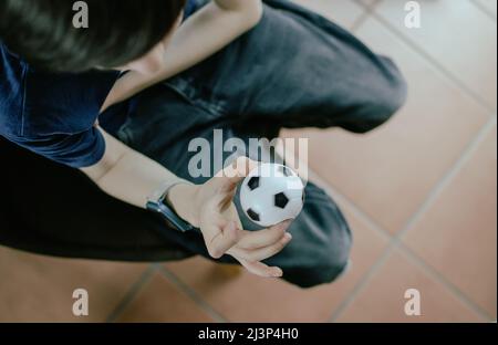 Garçon utilisant une boule de stress Banque D'Images