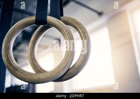 Le meilleur équipement pour travailler à la fois sur la résistance et la flexibilité. Gros plan sur les anneaux de gymnastique dans une salle de gym. Banque D'Images