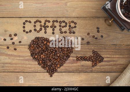Texte et flèche de grains de café, forme de coeur sur un arrière-plan en bois ancien et millésime de café. Concept de conception de café.. Banque D'Images