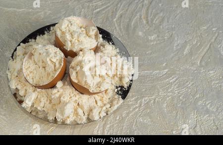 Poudre de protéine d'œuf sur une assiette et des coquilles d'œuf. Vue de dessus avec espace de copie. Nutrition sportive. Banque D'Images