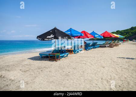 Parasols et chaises longues sur Virgin Beach, une plage de sable blanc à Karangsarem, à l'est de Bali, en Indonésie. Banque D'Images