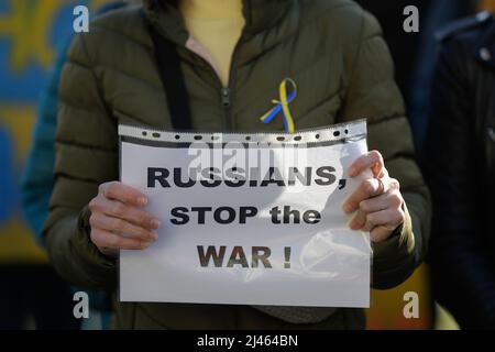 Détails avec les mains d'une femme ukrainienne tenant une bannière anti-guerre, pro-Ukraine et anti-Russie lors d'une manifestation anti-guerre à Bucarest, Roumanie. Banque D'Images