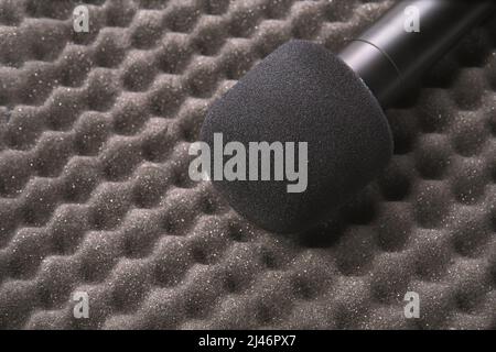 Concept de podcast. Enregistreur à microphone noir, clavier de l'ordinateur portable de contenu. Gros plan. Périphérique audio. Enregistrement de la production. Équipement de connaissances scolaires. Accueil enseignement en ligne. Gris Banque D'Images