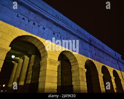 Vue à angle bas de la porte historique Äußeres Burgtor de Vienne, Autriche de nuit avec illuminations bleues et jaunes dans les couleurs du drapeau ukrainien. Banque D'Images