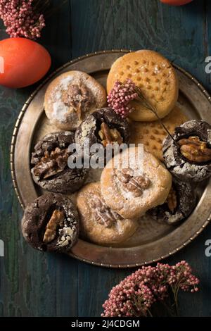 Biscuits aux noix de Pâques avec œufs de couleur et fleurs roses Banque D'Images