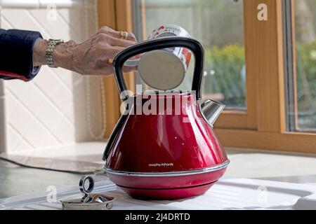 Remplissez la bouilloire électrique d'eau par la cuvette pour éviter de gaspiller de l'électricité Banque D'Images