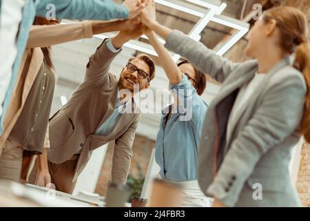 Les gens d'affaires en donnent cinq à leur collègue au bureau Banque D'Images