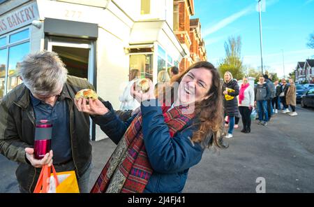 Brighton UK 15th avril 2022 - Mark et Colette Hubert ont été les premiers à faire la queue devant Ravens Bakery à Brighton le vendredi matin pour acheter leurs célèbres pains Hot Cross avant de partir à Liverpool pour voir leurs petits-enfants : Credit Simon Dack / Alay Live News Banque D'Images