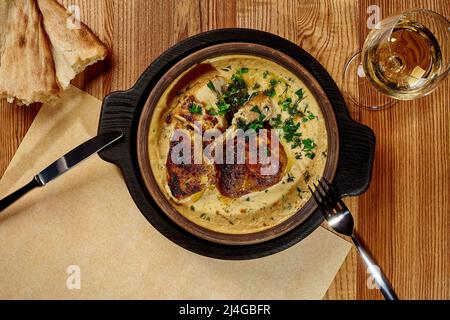 Poulet de style géorgien avec sauce aux noix servi dans du ketsi avec des shotis puri et du vin Banque D'Images