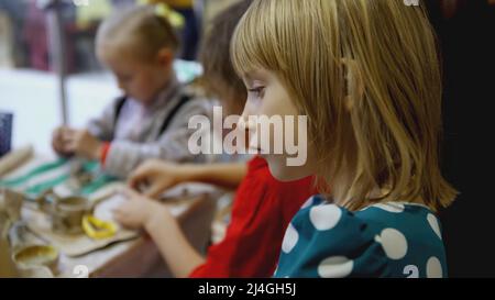 EKATERINBOURG, RUSSIE - 25 FÉVRIER 2022 : les filles participent à une classe de maître sur la modélisation à partir de la plastine. ART. Petites filles au festival Banque D'Images