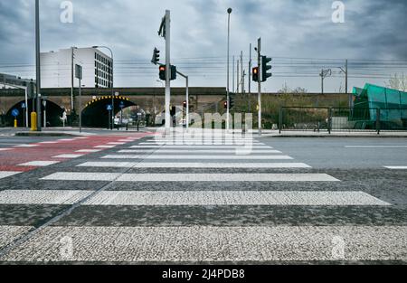 Passage pour piétons contrôlé par un feu de circulation. Tapis rouge à rayures blanches. Banque D'Images