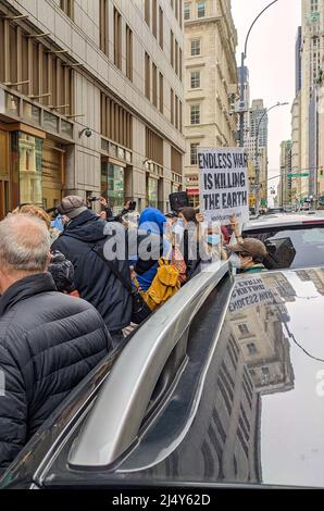 Le démonstrateur détient un panneau devant le bureau du service des recettes internes de Lower Manhattan exigeant d'arrêter la guerre, le 18 avril 2022. Banque D'Images