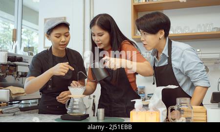 Trois de Barista préparer un café au café. Banque D'Images