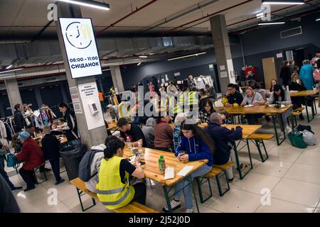 Varsovie, Pologne. 19th avril 2022. Les réfugiés mangent au centre d'accueil des réfugiés de l'exposition universelle de Varsovie. Selon les estimations du HCR, l'agence des Nations unies pour les réfugiés, cinq millions d'Ukrainiens sont partis depuis que la Russie a envahi l'Ukraine le 24th février. Près de trois millions de personnes ont franchi la frontière polonaise depuis l'Ukraine. À Varsovie, des milliers de personnes sont encore à l'abri dans le centre d'accueil de l'exposition mondiale pour les réfugiés - l'un des nombreux et deuxième plus grands abris pour réfugiés dans la capitale. (Photo par Attila Husejnow/SOPA Images/Sipa USA) crédit: SIPA USA/Alay Live News Banque D'Images