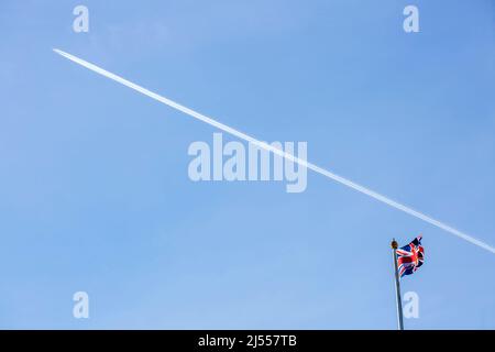 Un contrail est vu au-dessus d'un drapeau de l'Union volant sur le toit de Buckingham Palace dans le centre de Londres avant le jour de l'accession. Banque D'Images