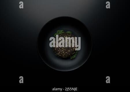 Hamburger de légumes noir sain sur une assiette noire, photo d'en haut Banque D'Images