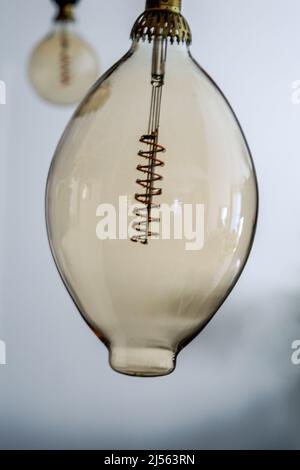 Vue rapprochée d'une ampoule électrique transparente montrant l'intérieur du filament en cuivre Banque D'Images