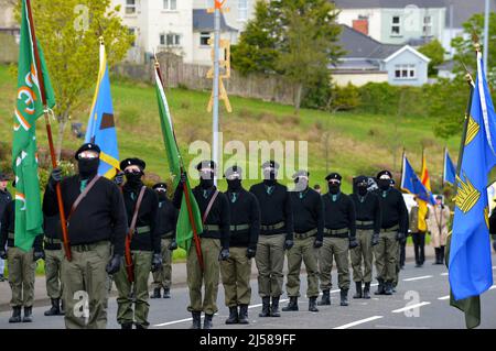Hommes et femmes masqués en uniforme paramilitaire lors d'un défilé républicain dissident du lundi de Pâques à Derry, Irlande du Nord, le 18 mars 2022. ©George Sweeney / Alamy stock photo Banque D'Images