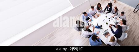 Groupe de l'Équipe Entreprises ethniques siégeant ensemble sur le lieu de travail dans un bureau moderne Banque D'Images