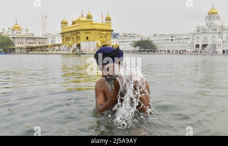 Amritsar, Inde. 21st avril 2022. AMRITSAR, INDE - AVRIL 21 : les fidèles sikhs pirent un plongeon dans le Saint sarovar à l'occasion de l'anniversaire de naissance de Guru Teg Bahadur en 400th, au Temple d'Or le 21 avril 2022 à Amritsar, Inde. (Photo par Sameer Sehgal/Hindustan Times/Sipa USA) crédit: SIPA USA/Alay Live News Banque D'Images