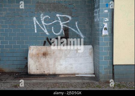 16 décembre 2021, Berlin, Allemagne, Europe - un vieux matelas sale et illégalement disposé s'appuie sur un mur couvert de graffiti sur le côté de la rue dans le quartier de Mitte. [traduction automatique] Banque D'Images