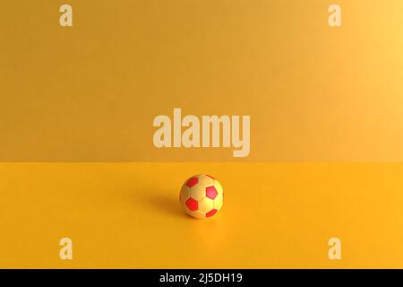3d illustration. 3d rendu d'une balle rouge et jaune sur fond jaune. Ressources de tasse de mau Banque D'Images