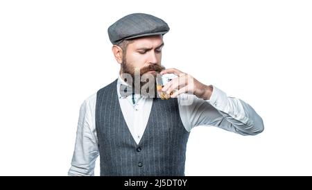 Le sommelier goûte des boissons chères. Homme barbu portant un costume et buvant du whisky, du brandy, du cognac. Barbu dedans est tenant un verre de whisky Banque D'Images