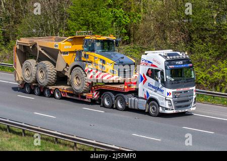Crynant Plant Heavy Haulage VOLVO FH16 6x2T TA XHSL 16123cc camion diesel remorquant une remorque articulée à chargeur bas avec B40E grand tombereau articulé ; camions de livraison de transport, camion, véhicules lourds, transport, camion, transporteur de marchandises, véhicule, HGV de l'industrie européenne du transport commercial, M6 à Manchester, Royaume-Uni Banque D'Images