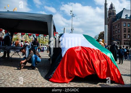 Une voiture est photographiée couverte d'un grand drapeau palestinien pendant la démonstration. Des centaines de personnes se sont rassemblées sur la place du Dam à Amsterdam pour montrer leur soutien à la Palestine et dénoncer les récentes violences du gouvernement israélien contre les Palestiniens. La « manifestation d'urgence » a été organisée en réponse à la dernière agression d'Israël contre les Palestiniens le 15 avril à la mosquée Al-Aqsa à Jérusalem. Plus de 150 Palestiniens ont été blessés en jetant des pierres et des feux d'artifice et les forces israéliennes ont tiré des grenades lacrymogènes et des gaz lacrymogènes. Banque D'Images