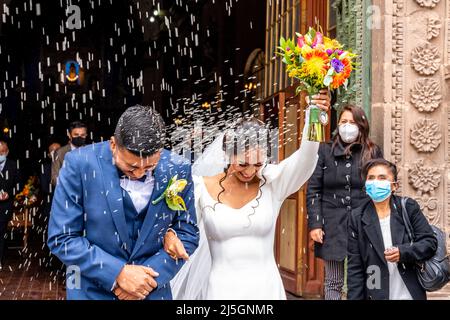 Un jeune couple péruvien quitte la cathédrale après s'être marié, la Plaza de Armas, Puno, Pérou. Banque D'Images