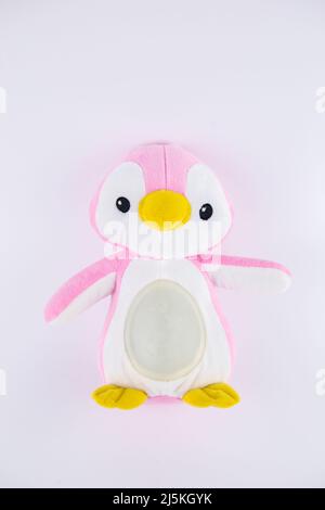 un jouet doux pour enfants de pingouin rose sur fond blanc Banque D'Images