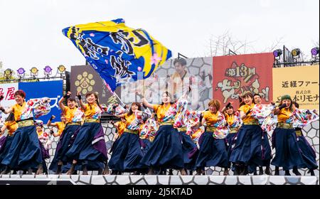 Une équipe japonaise de danseurs de Yosakoi dansant en tuniques à manches longues yukata sur une scène en plein air au festival Kyusyu Gassai à Kumamoto. Banque D'Images